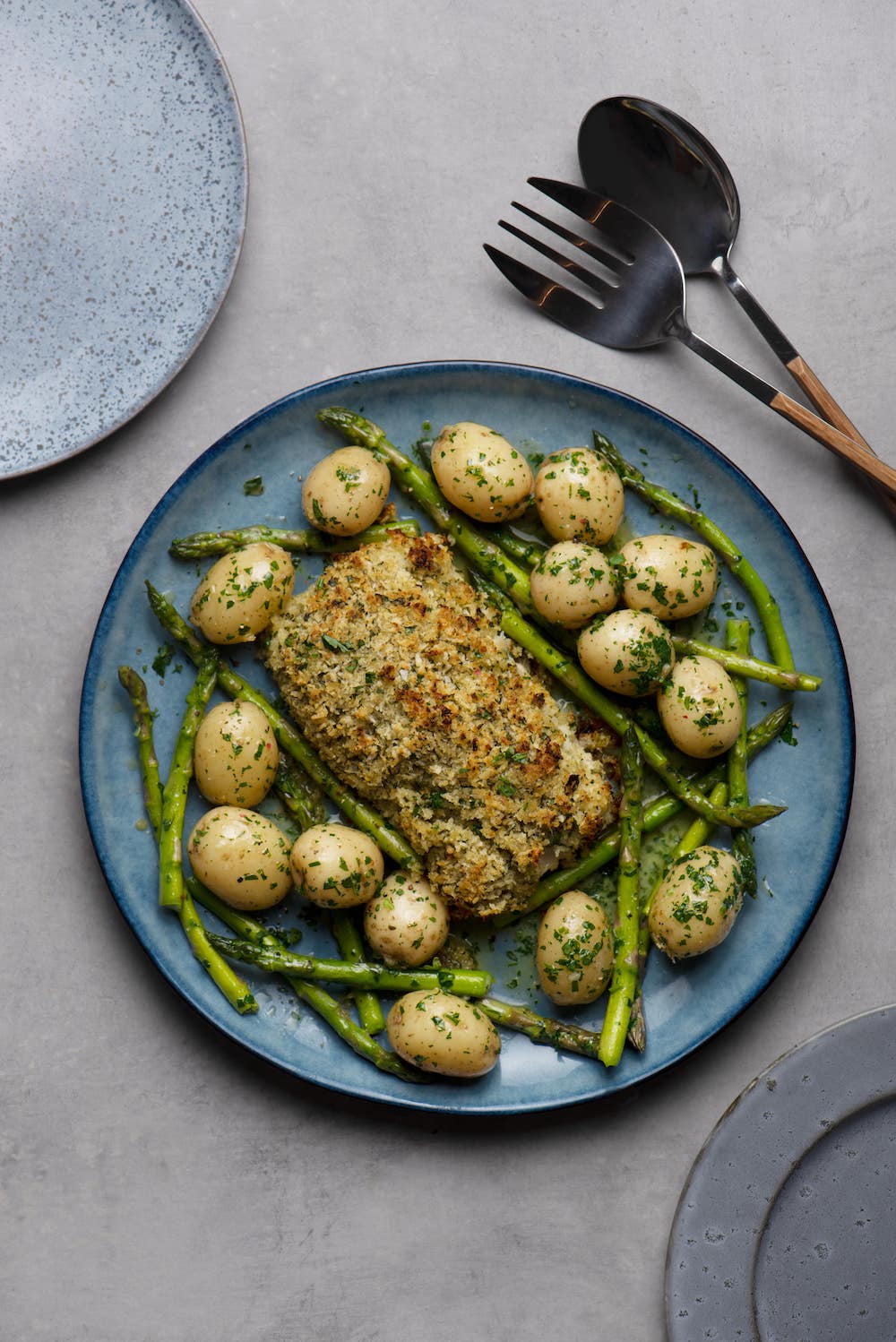 Cod loin baked with a lemon and herb crust, buttery new potatoes and asparagus