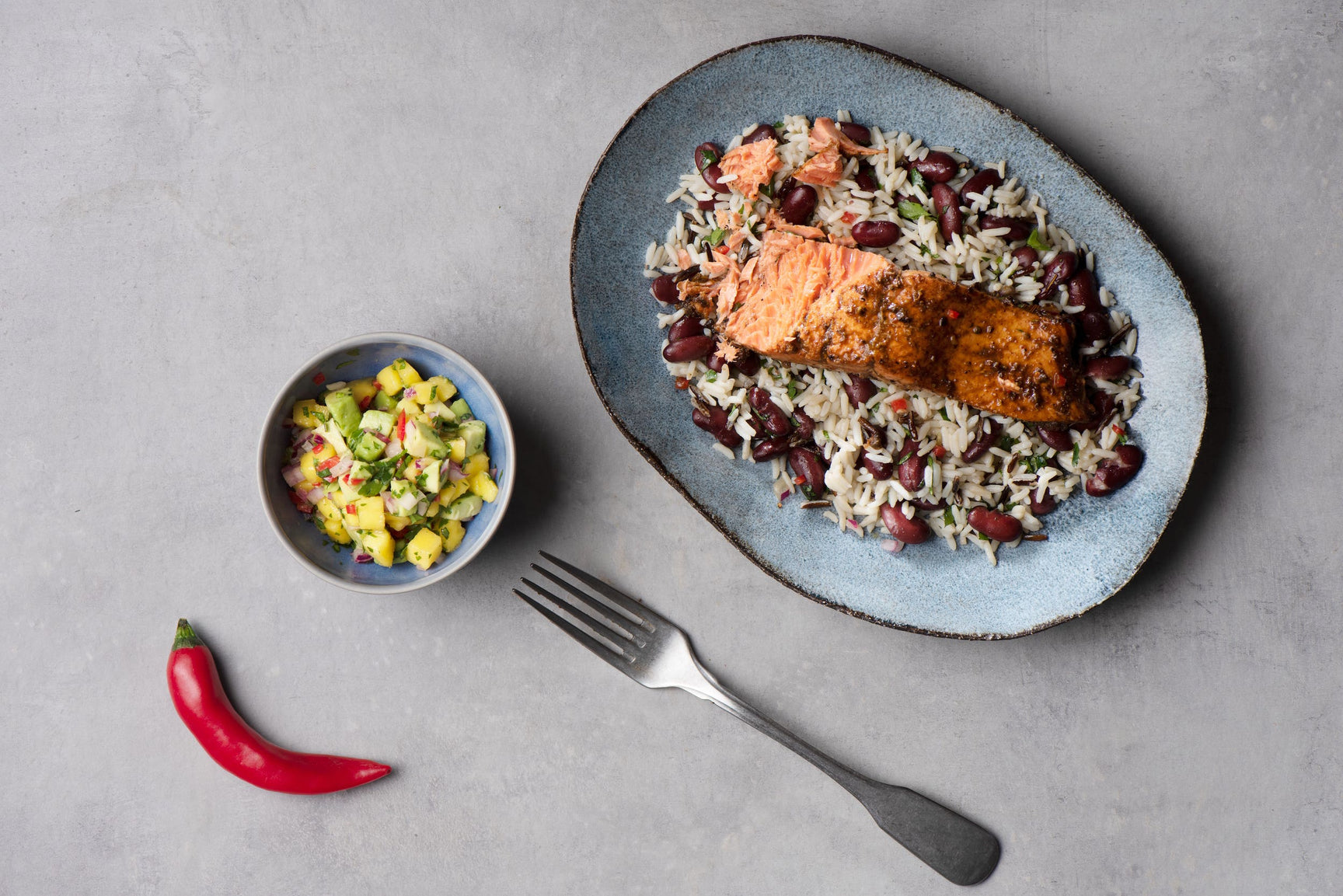 Caribbean-style sockeye salmon fillets with wild rice and a mango and avocado salsa