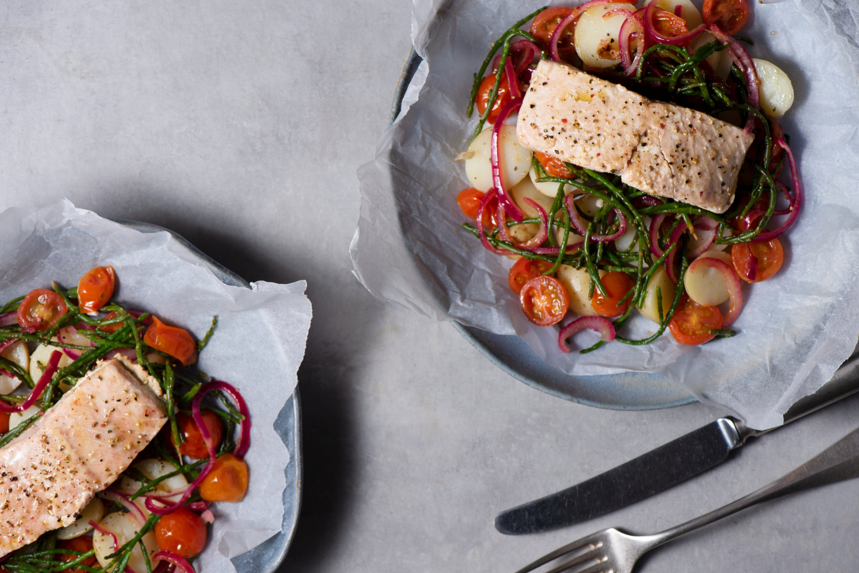 Keta salmon and new potatoes cooked en papillote, with samphire and cherry tomatoes